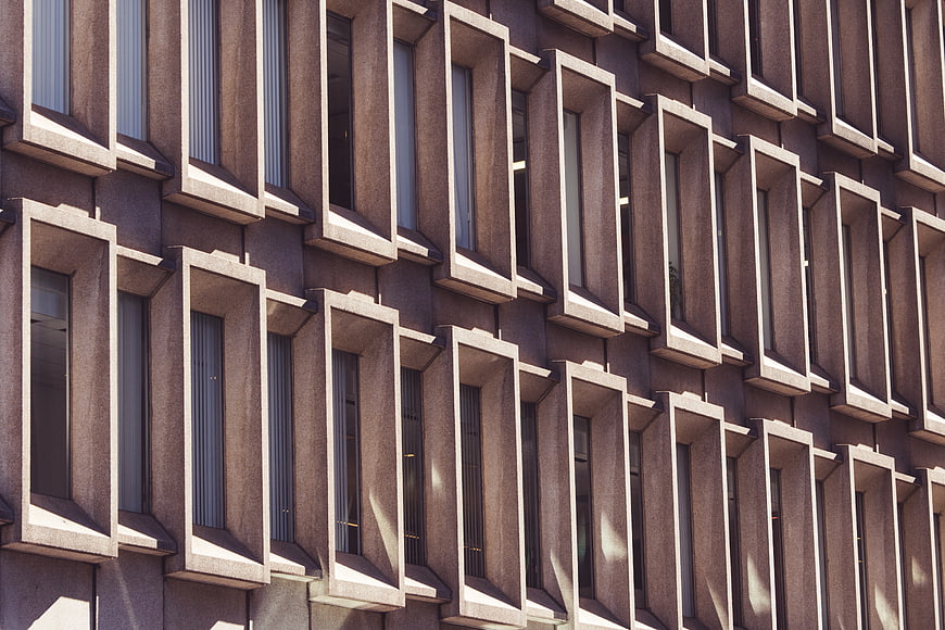 Modern Concrete Building Facade with Geometric Window Pattern