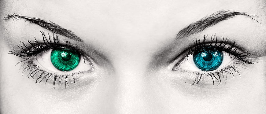 Close-up of woman's eyes with green and blue irises