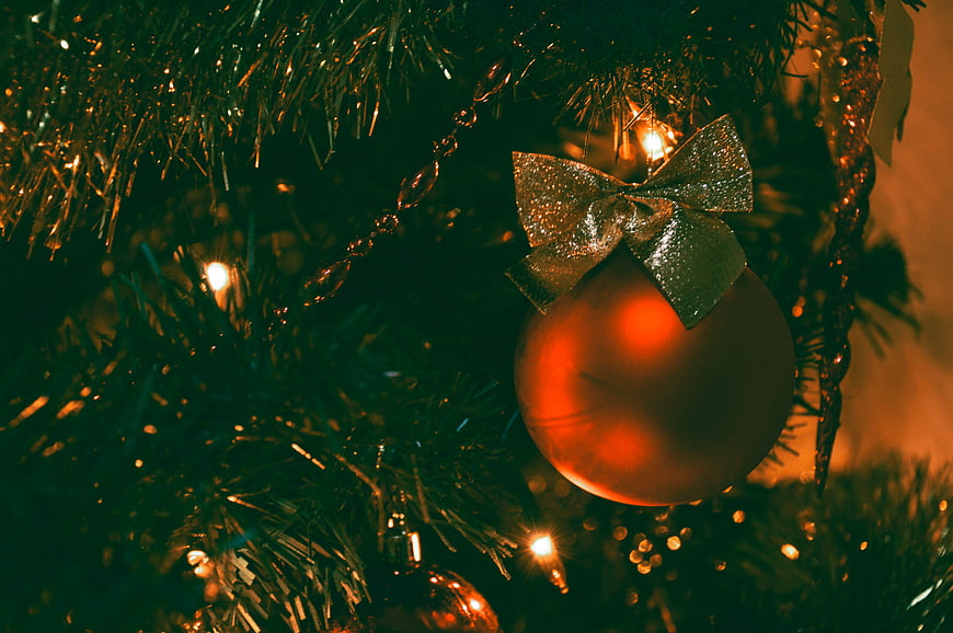 Close-up of Christmas Tree Ornament with Gold Bow and Lights