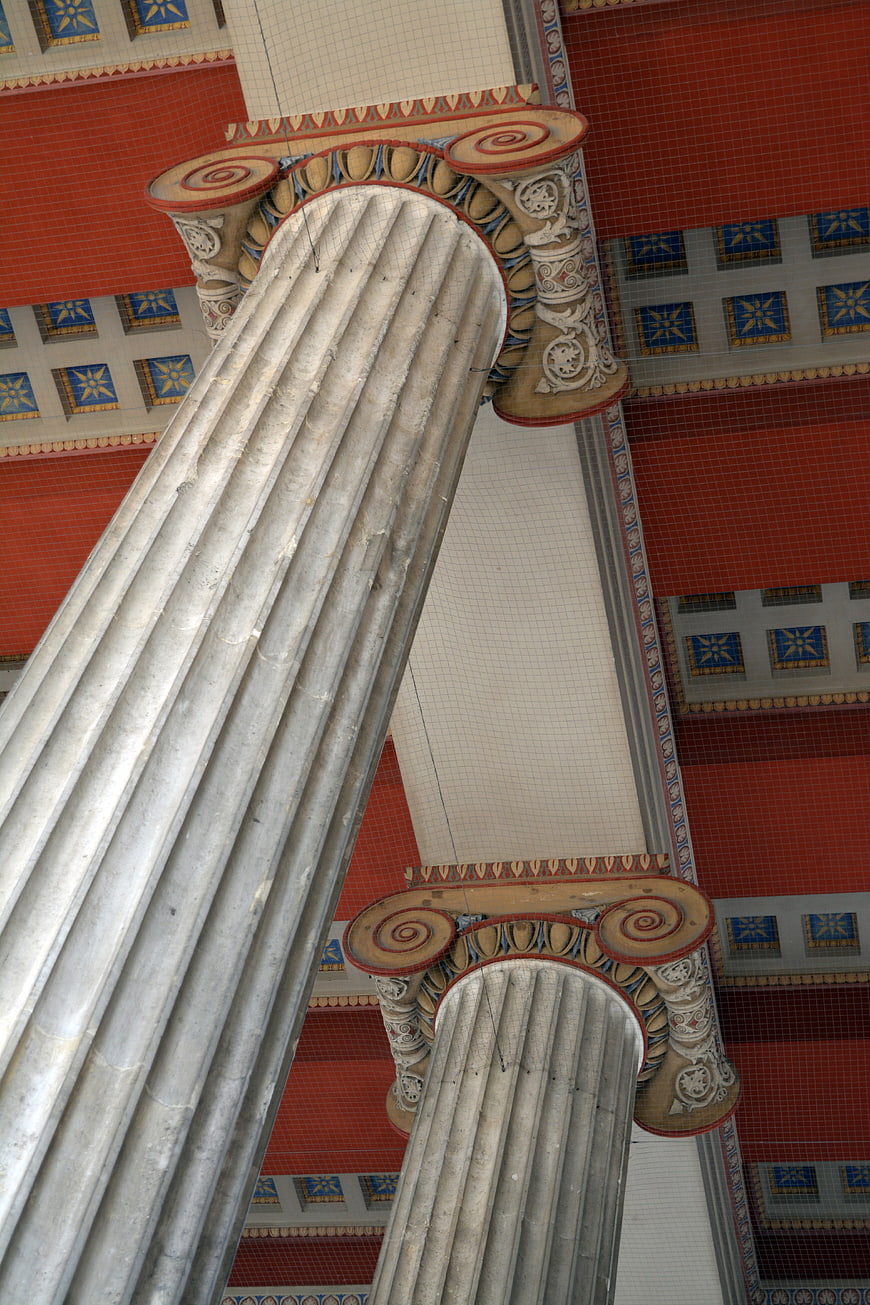 Low Angle View of Ornate Ionic Columns and Decorative Ceiling