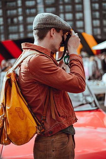 Man with Camera and Backpack at Outdoor Market
