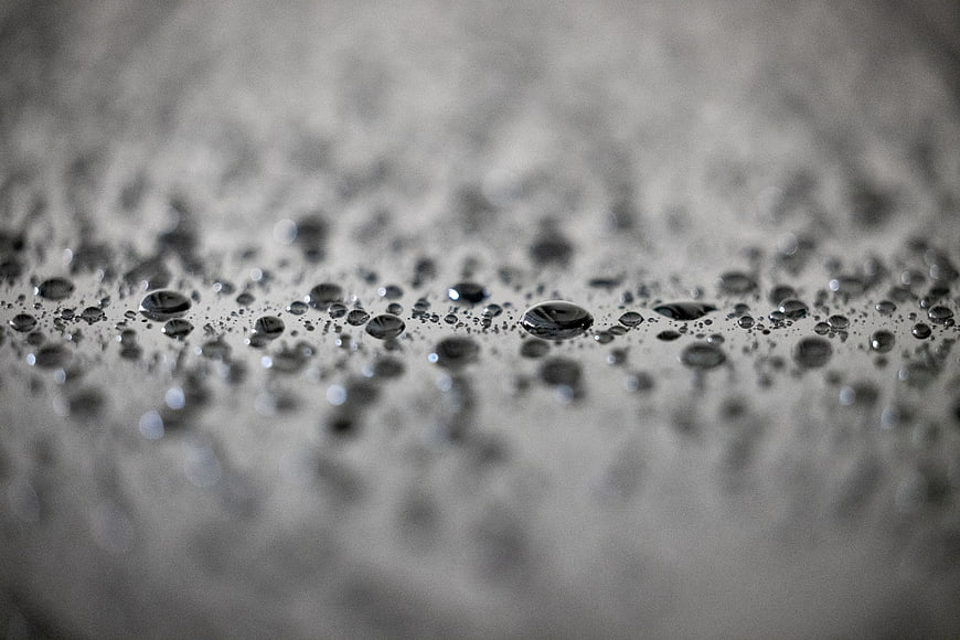 Macro water droplets on textured surface in black and white