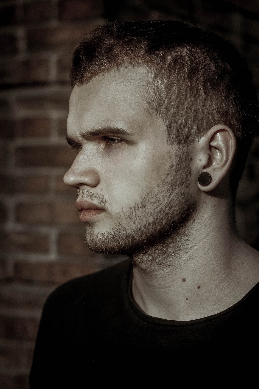 Profile Portrait of Young Man with Beard and Earring