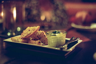 Warm Bread and Dip on Plate in Dim Restaurant
