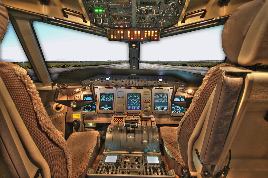 Airplane cockpit interior view with runway background