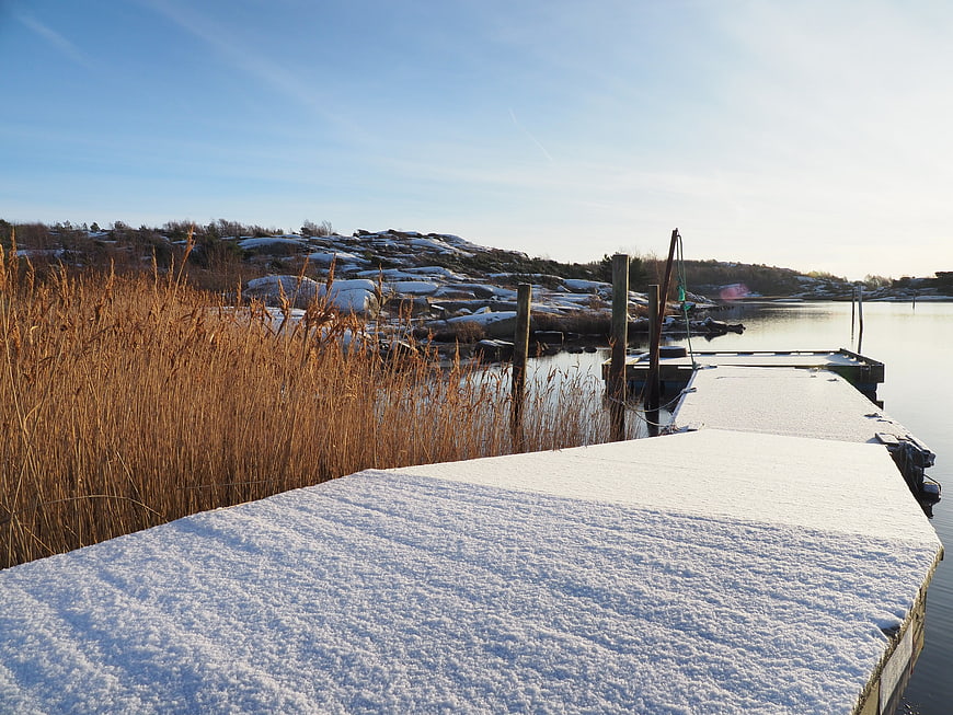 Snow-covered wooden dock in winter landscape