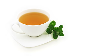 White Cup of Herbal Tea with Fresh Mint Leaves on White Background