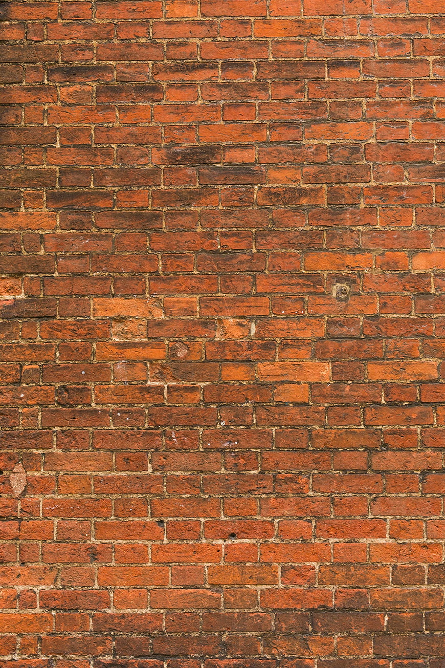 Textured Red Brick Wall Background with Weathered Grout