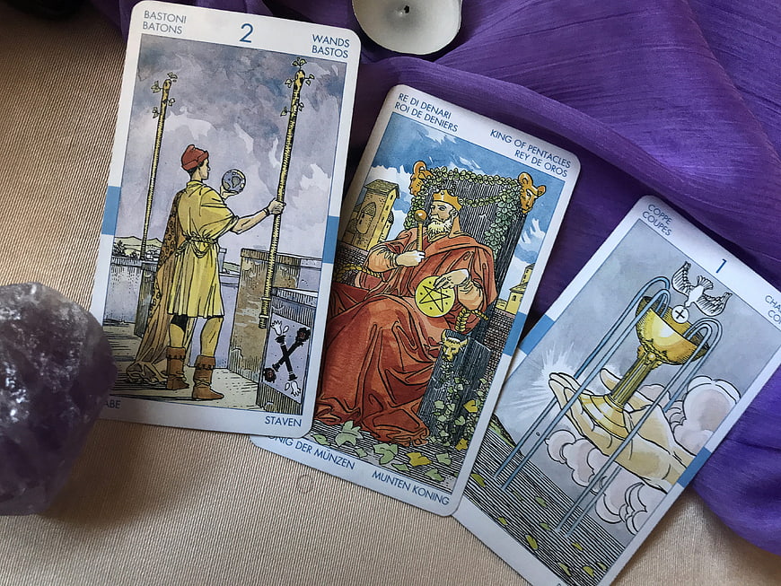 Three Tarot Cards on Purple Cloth with Amethyst Crystal