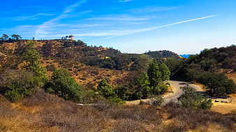 Griffith Observatory on a sunny day with winding road