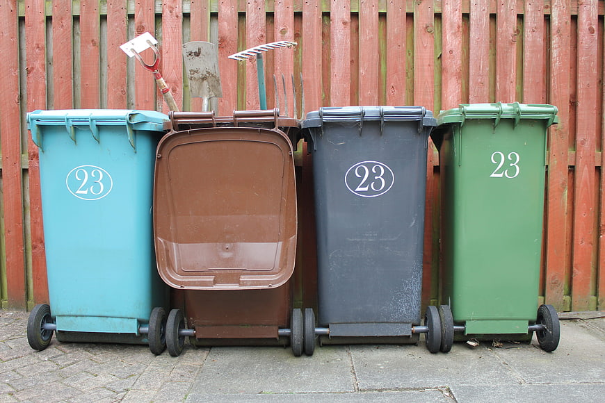 Four colored recycling bins with number 23 lined up