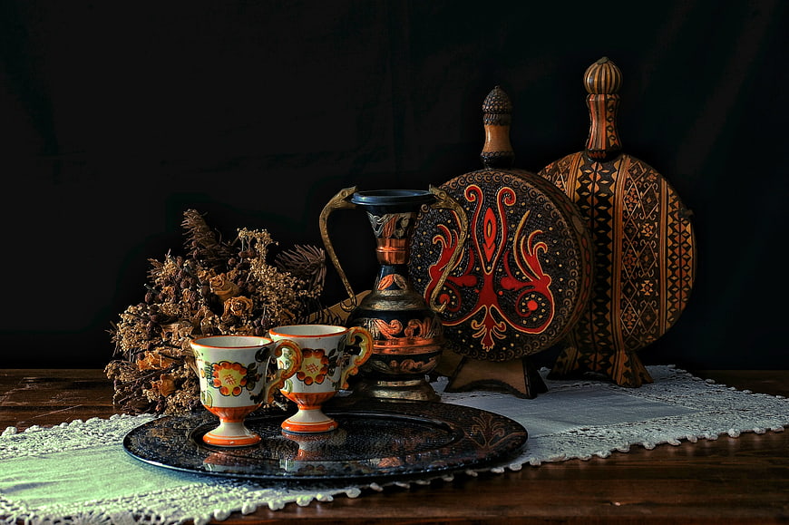 Traditional Embroidered Decor and Teacups on Wooden Table