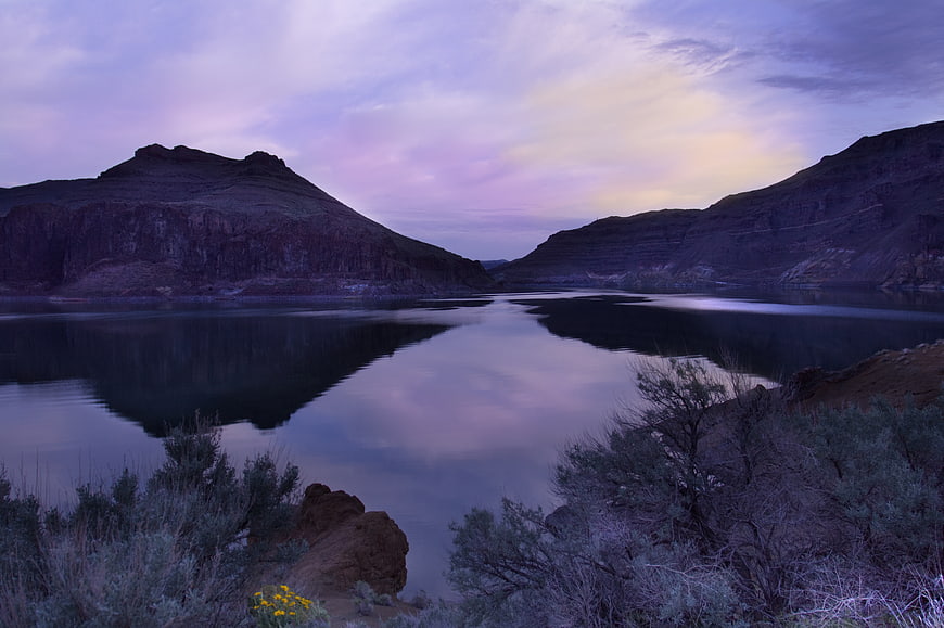Serene Purple Lake Reflection Between Mountains at Dusk