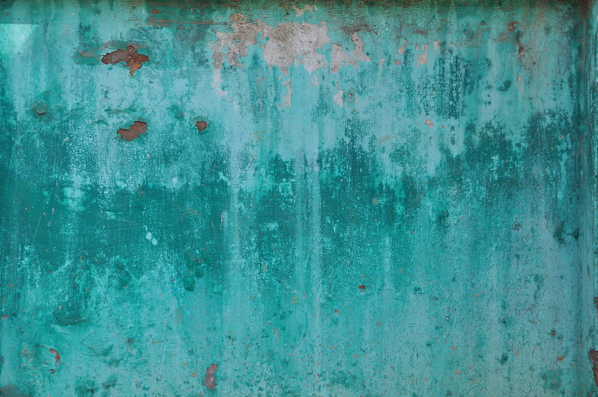 Weathered turquoise metal texture with peeling paint and rust