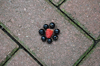 Raspberry and blackberries arranged on paving stones