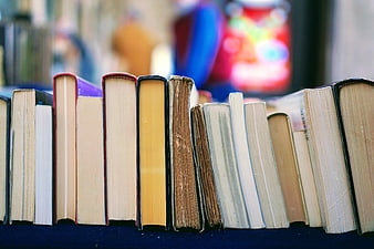 Close-up of vintage book spines on a shelf