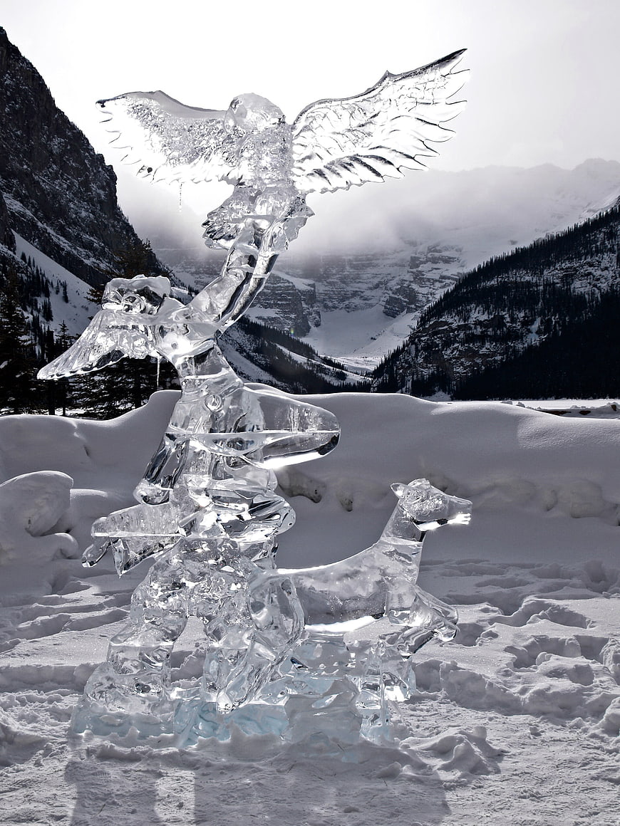 Ice Sculpture of Eagle and Deer in Snowy Mountain Landscape