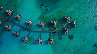 Aerial View of Overwater Bungalows in Turquoise Lagoon