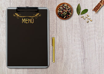 Restaurant Menu Clipboard with Spices and Pen on Wood