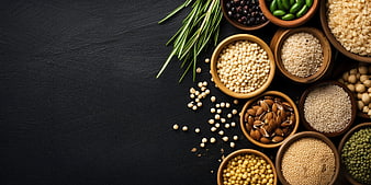 Assorted healthy seeds and spices in wooden bowls on dark background