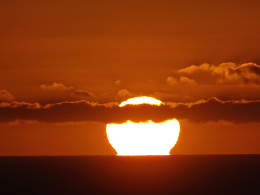 Dramatic Orange Sunset Over Ocean Horizon