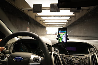Car interior with GPS navigation phone in tunnel