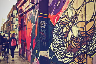 Colorful Street Art Mural on Urban Wall with Pedestrians