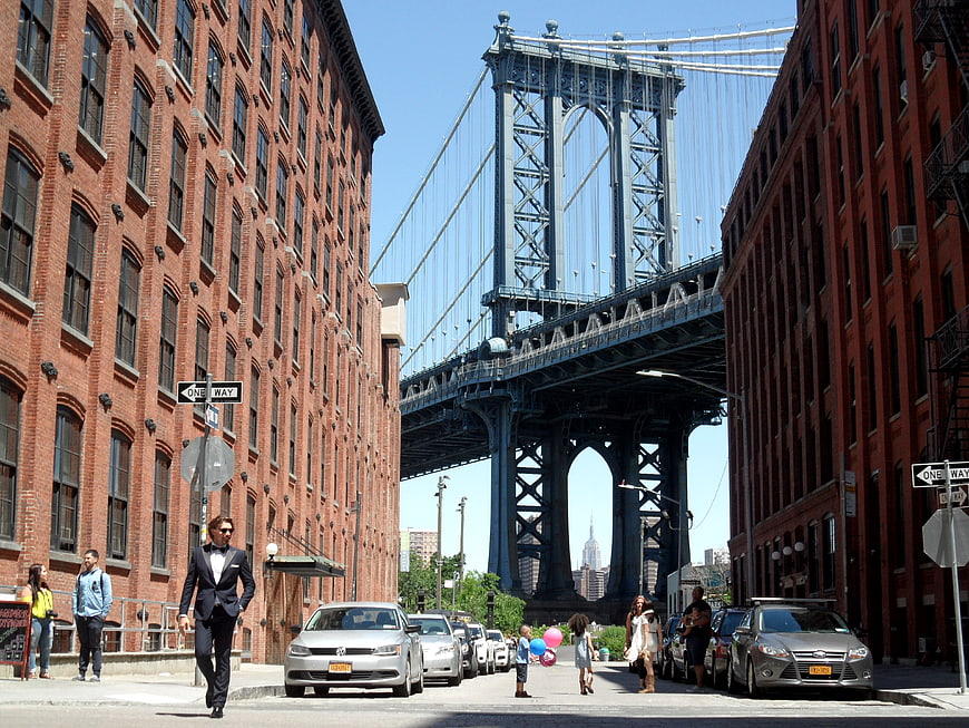 Man in Tuxedo Walking Under Manhattan Bridge in DUMBO
