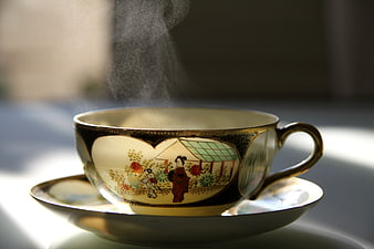 Steaming Japanese Tea Cup with Traditional Artwork