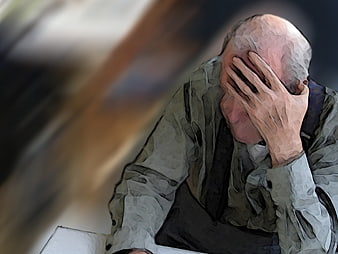 Senior man holding head in distress, dementia concept