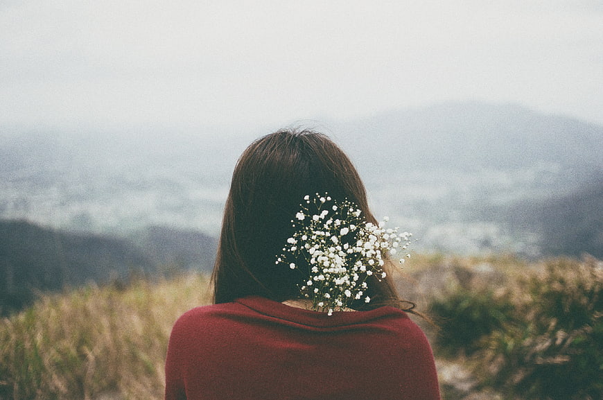 Woman with Baby's Breath Flowers Looking at Mountain View