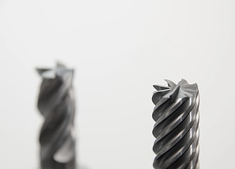 Close-up of metal drill bits on white background