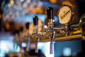 Close-up of Staropramen beer tap handle in a bar