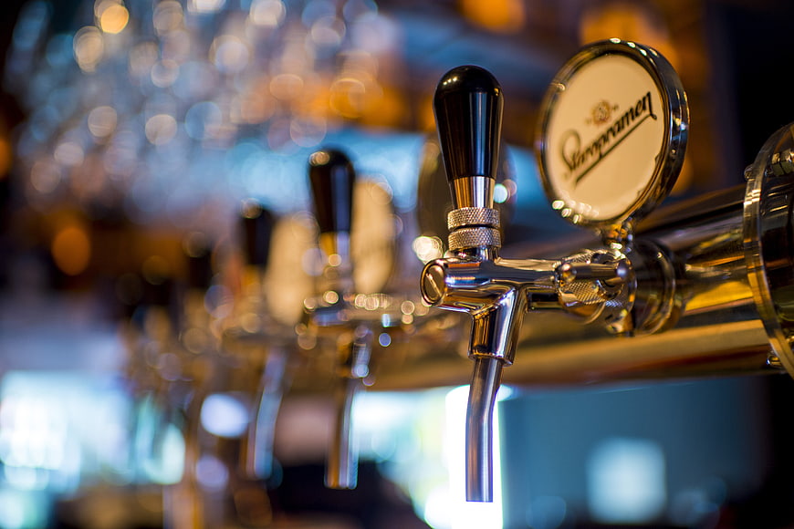 Close-up of Staropramen beer tap handle in a bar