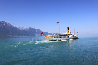 Classic Steamship Cruising On Lake Geneva With Alpine Mountains In Background
