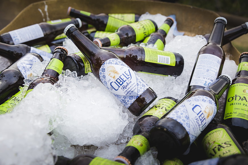 Assorted craft beer bottles chilling in crushed ice