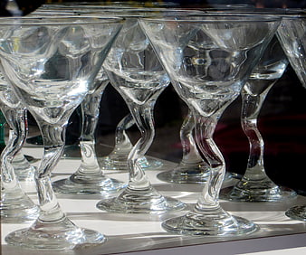 Twisted stem martini glasses on white surface