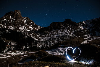 Light Painting Heart Shape in Snowy Mountain Landscape at Night