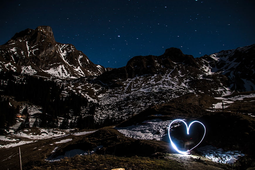 Light Painting Heart Shape in Snowy Mountain Landscape at Night