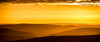Golden Sunset Over Rolling Hills Silhouette
