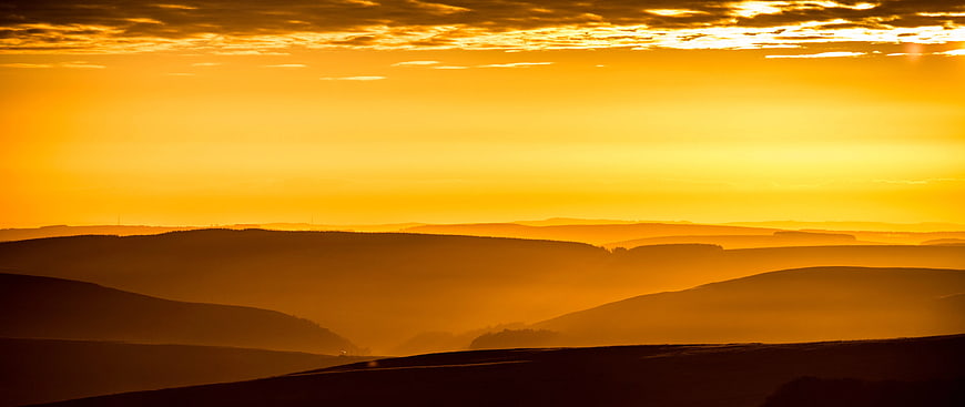 Golden Sunset Over Rolling Hills Silhouette