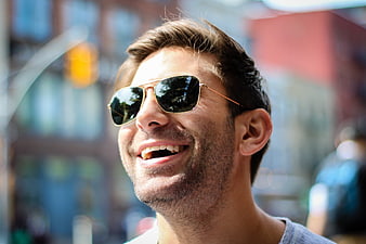 Happy Man Laughing with Sunglasses in Urban Setting