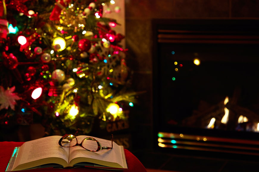 Cozy Christmas Scene with Book, Glasses, and Fireplace