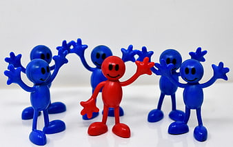 Red leader figure standing among blue team members