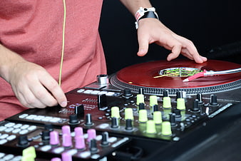 DJ Hands Mixing on Turntable and Controller