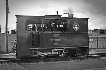 Vintage Black and White Steam Locomotive on Tracks