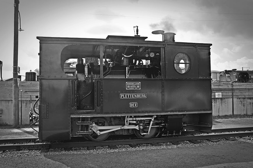 Vintage Black and White Steam Locomotive on Tracks