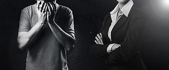 Sad man covering face and confident businesswoman with crossed arms