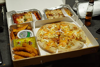 Korean pizza delivery box with sides and dipping sauces