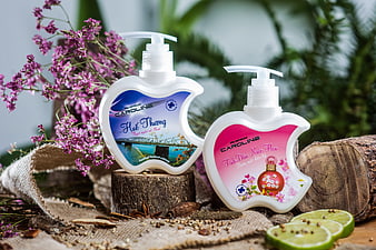 Apple-shaped perfume bottles with flowers and lime slices